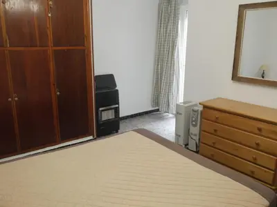 a bedroom with a bed and a dresser and a mirror at Nautilo, 8º-15 in Cullera