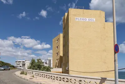 a building with a sign on the side of it at Pleno Sol, 45 in Cullera