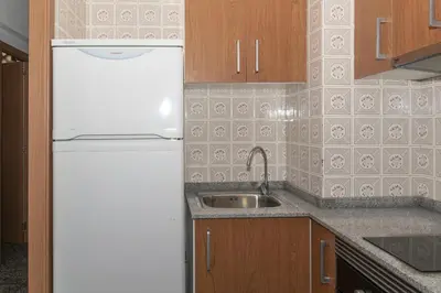 a kitchen with a white refrigerator and a sink at Prado, A-7º-72 in Cullera