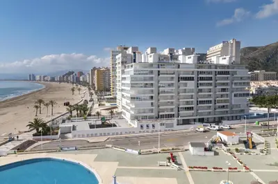 a large building next to a beach and the ocean at Prado, A-7º-72 in Cullera