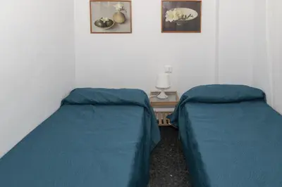two beds in a room with blue sheets at Prado, B-6º-64 in Cullera