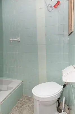 a bathroom with a toilet and a bath tub at Provence, 5º-17 in Cullera