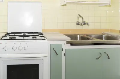 a kitchen with a stove and a sink at Provence, 5º-17 in Cullera