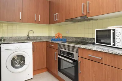 a kitchen with a washing machine and a microwave at Provence, 5º-18 in Cullera