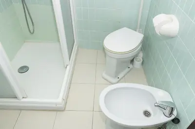 a bathroom with a toilet and a sink and a shower at Provence, 7º-25 in Cullera