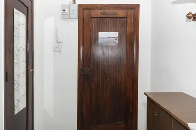 a wooden door in a room with a desk at Provence, 7º-25 in Cullera