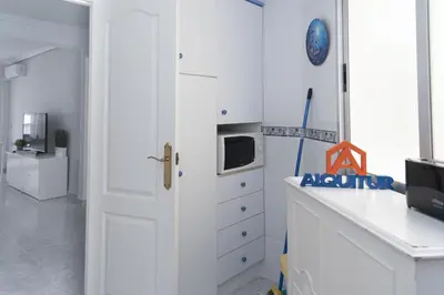 a kitchen with a white cabinet and a microwave at Saint Germain 7/B1, 8º-16 in Cullera