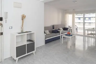 a living room with a couch and a table at Saint Germain 7/B1, 8º-16 in Cullera