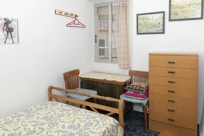 a bedroom with a desk and a bed and a window at Santa Marta, I-A 7º-19 in Cullera