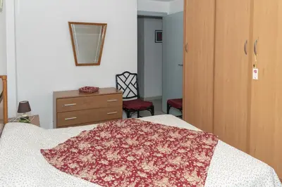 a bedroom with a bed and a dresser and a mirror at Santa Marta, I-A 7º-19 in Cullera