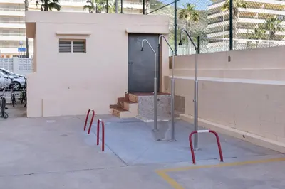 a parking lot with red poles in front of a building at Santa Marta, Iii-A 7º-16 in Cullera