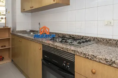 a kitchen with a stove top oven next to a sink at Seniades, 6º-16 in Cullera