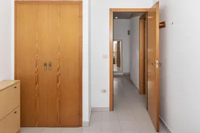 a hallway with two wooden doors in a room at Seniades, 6º-16 in Cullera