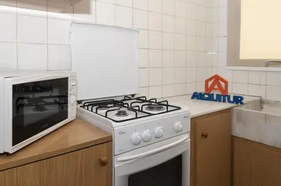 a kitchen with a white stove and a microwave at Trianon, 5º-29 in Cullera