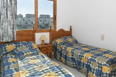 a bedroom with two beds and a window at Villas Cap Blanc, 1-31 Cab I-36 in Cullera