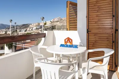a white table and chairs on a balcony with a view at Villas Cap Blanc, 1-31 Cab I-36 in Cullera