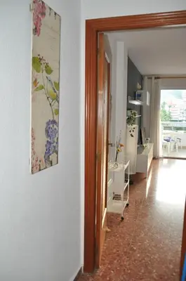 a living room with a painting on the wall at Palm Tree Cullera in Cullera