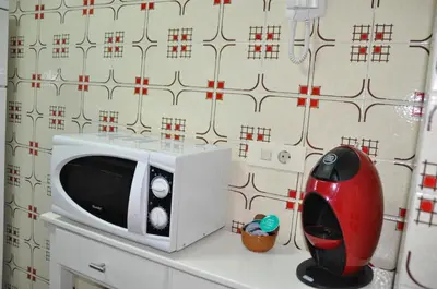 a microwave sitting on top of a kitchen counter at Palm Tree Cullera in Cullera
