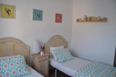a bedroom with two beds and a night stand with a nightstand at Palm Tree Cullera in Cullera