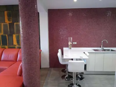 a living room with a red couch and a white table at Apartamentos BARRACA in Valencia