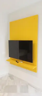 a yellow tv hanging on a wall at Apartamentos BARRACA in Valencia