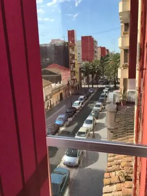 a view from a window of a street with parked cars at Apartamentos BARRACA in Valencia