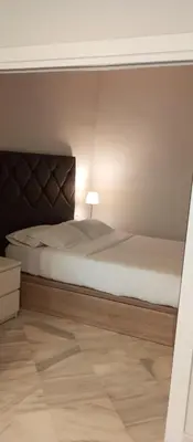 a bedroom with a bed with a headboard and a lamp at Apartamentos BARRACA in Valencia