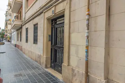a building with a door on the side of a street at Apartamento cerca de la Playa y el Centro in Valencia