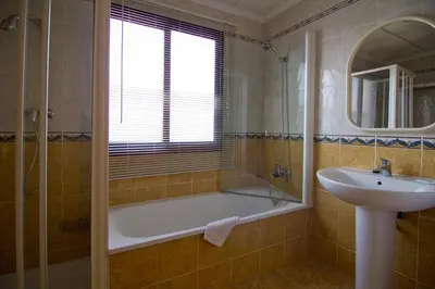 a bathroom with a bath tub and a sink at Portocanet Complejo Turístico in Canet de Berenguer