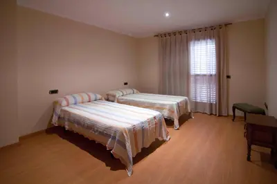 a bedroom with two beds and a window at Portocanet Complejo Turístico in Canet de Berenguer