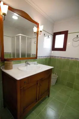 a bathroom with a sink and a mirror at Portocanet Complejo Turístico in Canet de Berenguer