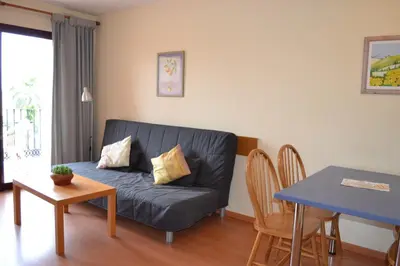 a living room with a couch and a table at Portocanet Complejo Turístico in Canet de Berenguer