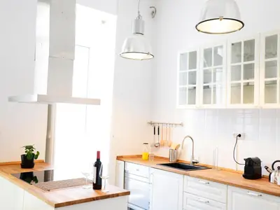a white kitchen with white cabinets and a sink at City Hall Correos in Valencia
