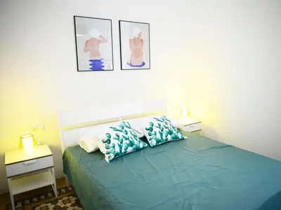a bedroom with a bed with blue pillows on it at City Hall Correos in Valencia