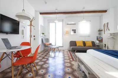 a bedroom with a bed and a living room at FLORIT FLATS - Ruzafa Attic with Private Terrace in Valencia