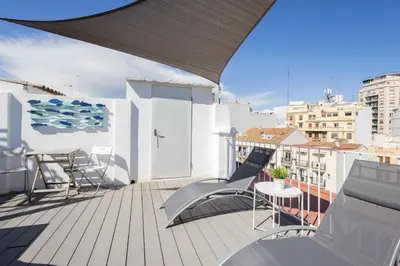 a balcony with chairs and a table on a building at FLORIT FLATS - Ruzafa Attic with Private Terrace in Valencia