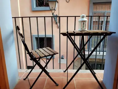 a chair on a balcony with a lamp on it at FLORIT FLATS - The Central Market and Lonja Apartment in Valencia