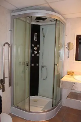a shower with a glass door in a bathroom at Hotel La Villa in Requena