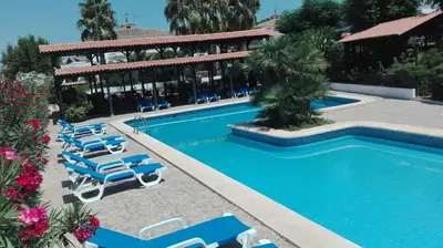a swimming pool with lounge chairs and a resort at Hotel La Carreta in Chiva