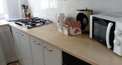 a kitchen counter with a stove and a microwave at La Roqueta completo en pleno centro in Valencia