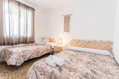 a room with two beds and a table with a lamp at Casa Victoria in Valencia