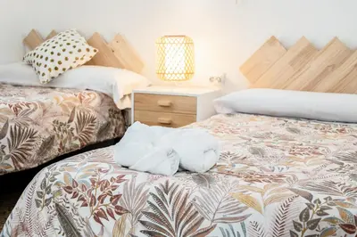 a bedroom with two beds with towels on the bed at Casa Victoria in Valencia