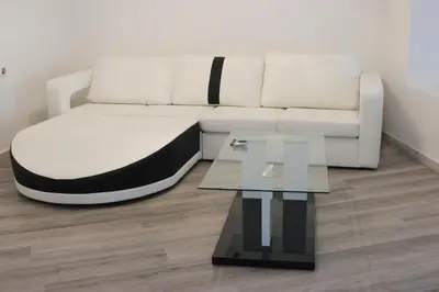 a living room with a white couch and a glass table at Apartment in Little Venice in Port Saplaya