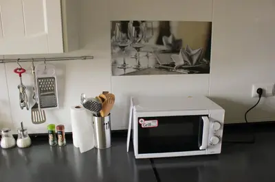 a microwave on a counter in a kitchen at Apartment in Little Venice in Port Saplaya