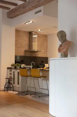 a kitchen with a table and yellow chairs in a room at FLORIT FLATS - Serranos Apartment in Valencia