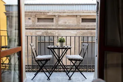 a table and two chairs on a balcony at FLORIT FLATS - Serranos Apartment in Valencia