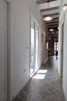 an empty hallway with a floor of tile at FLORIT FLATS - Serranos Apartment in Valencia