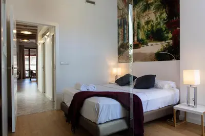 a bedroom with a bed and a painting on the wall at FLORIT FLATS - Serranos Apartment in Valencia