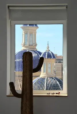a window with a view of a building with a scarf at Atico Valencia Sorolla in Valencia