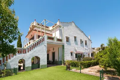 a large white house with a lawn in front of it at Villamilagro in Sueca